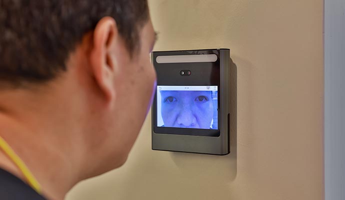 A person using a retinal scanner for security
